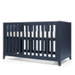 Midnight navy cotbed with vertical slats and open front, angled view