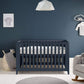 Midnight navy cotbed with vertical slats and open front, viewed straight-on