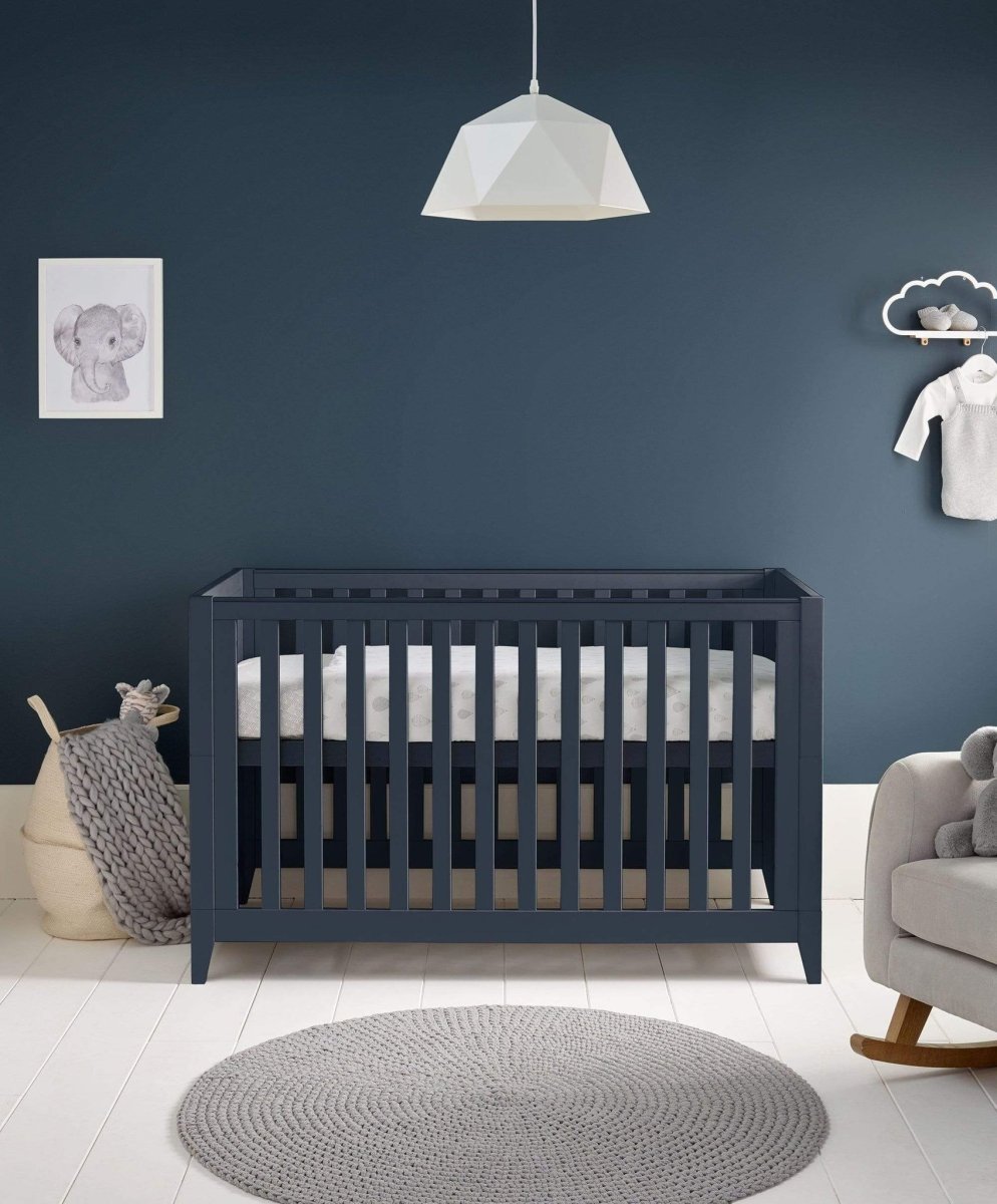 Midnight navy cotbed with vertical slats and open front, viewed straight-on