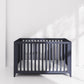 Midnight navy cotbed with vertical slats on all sides and open front