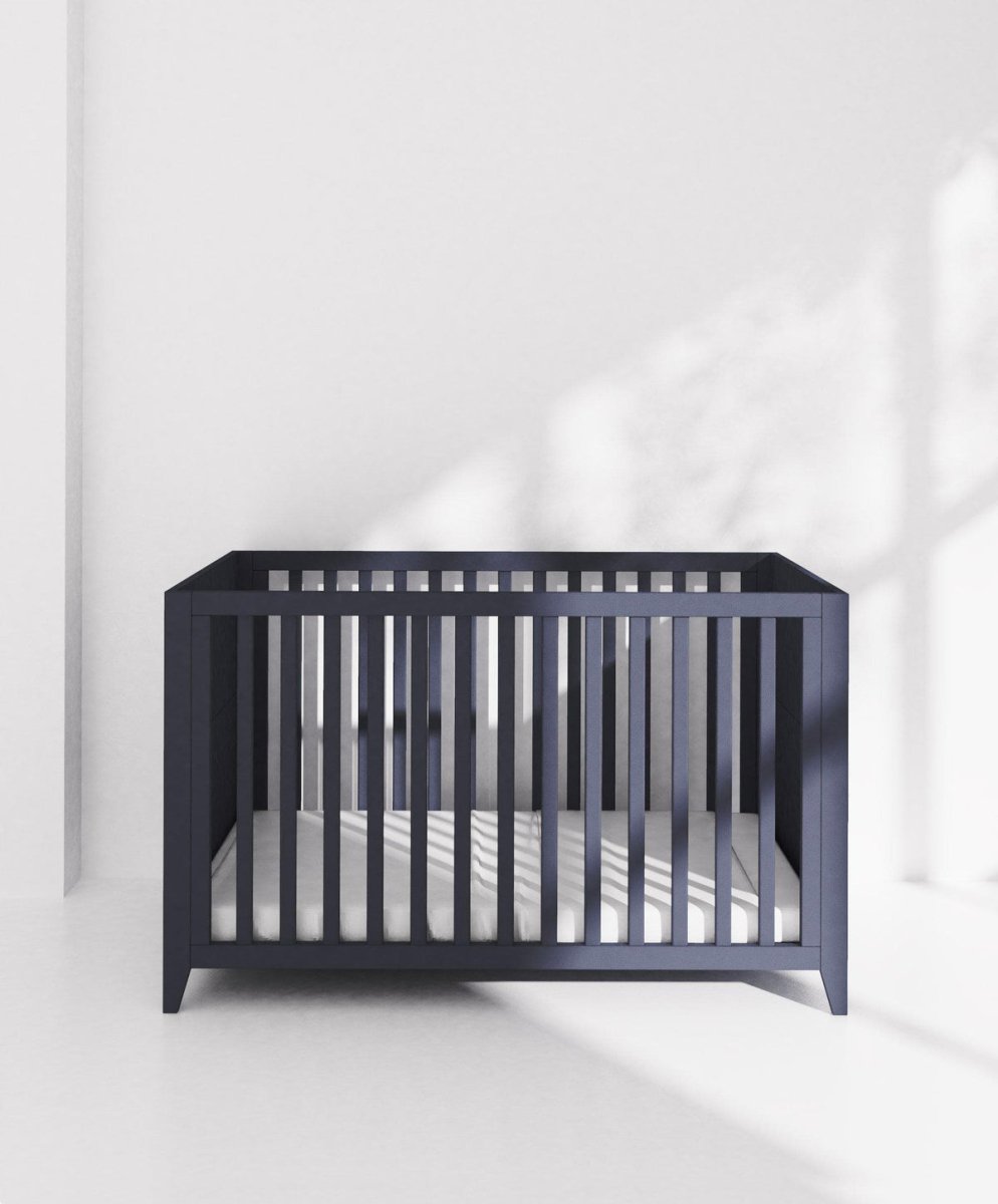 Midnight navy cotbed with vertical slats on all sides and open front