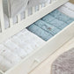 White Mia cotbed with white and light-blue patterned mattress pads