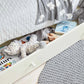 White Mia cotbed with grey elephant-patterned bedding and folded quilt