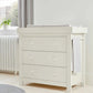 White Mia dresser changer with three drawers and raised changing pad on top