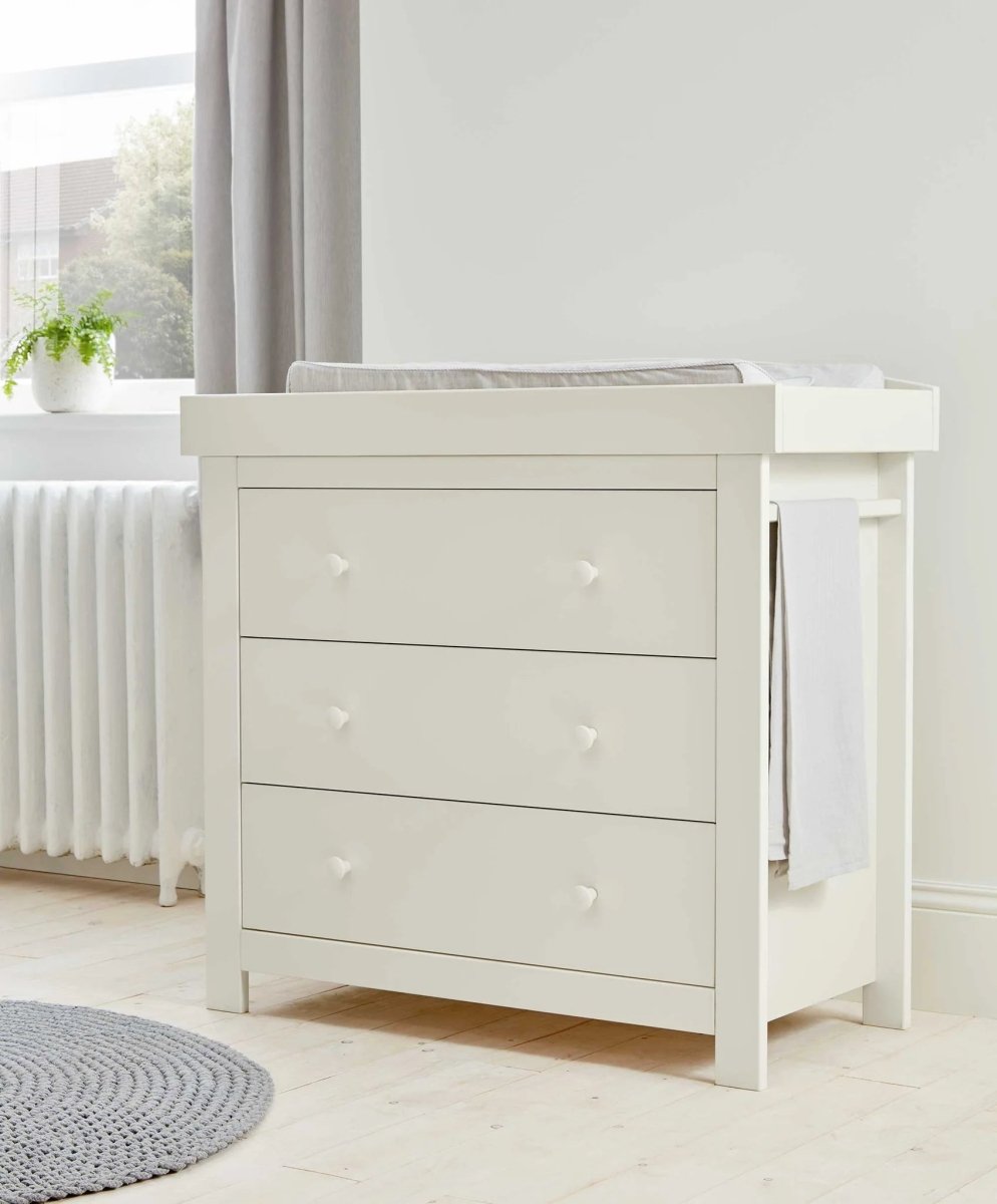White Mia dresser changer with three drawers and raised changing pad on top