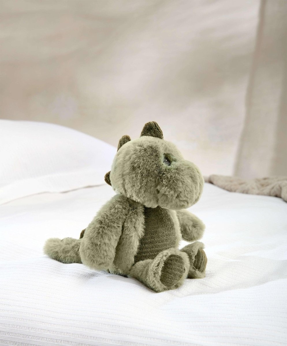 Green plush dinosaur toy with small horn, front paws tucked, stitched eyes