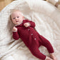 Burgundy Santa-style romper with white scalloped collar and button front
