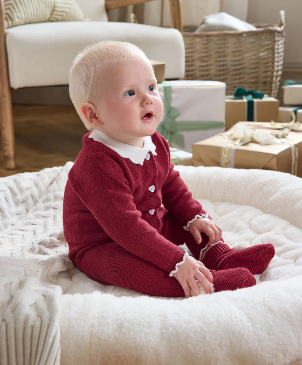 Burgundy Santa-style footed romper with white collar, snap button placket