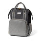 Black and gray mummy backpack with front pocket, zigzag trim, and top handle