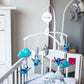 Baby music mobile with plush clouds, fish, stars, and whale on crib