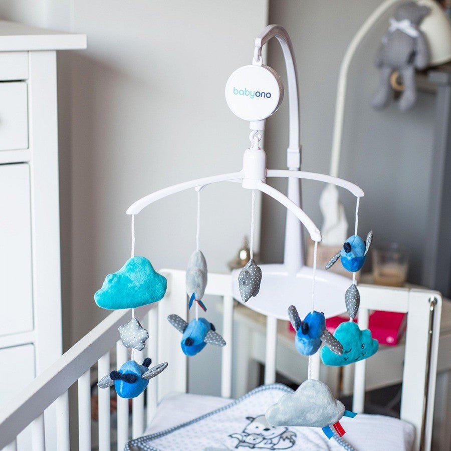Baby music mobile with plush clouds, fish, stars, and whale on crib