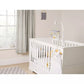 Hanging baby mobile over white crib with stars and cloud decorations