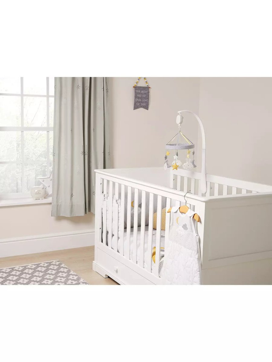 Hanging baby mobile over white crib with stars and cloud decorations