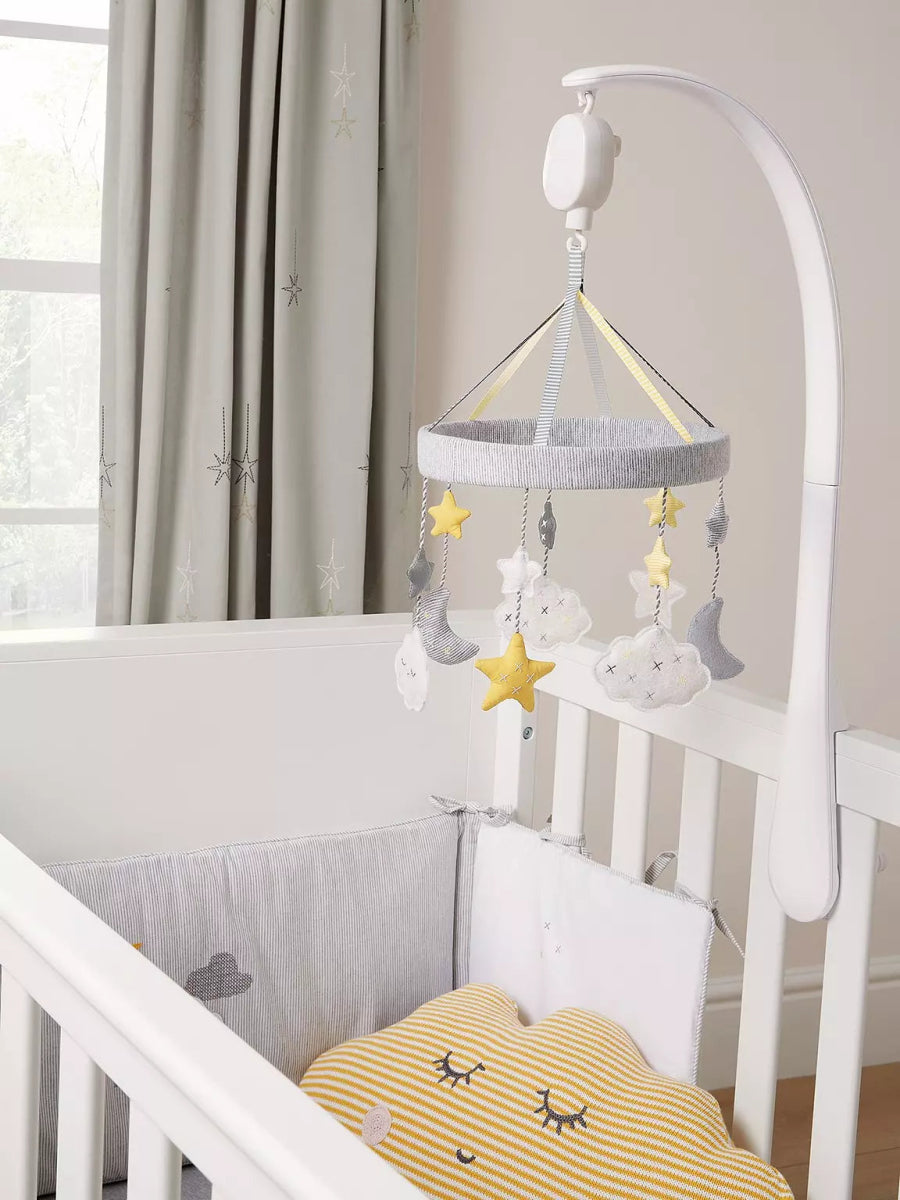 Baby musical mobile on crib with star, cloud, and moon ornaments