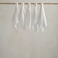 Muslin squares, white cloth squares hanging in a row with gathered tops