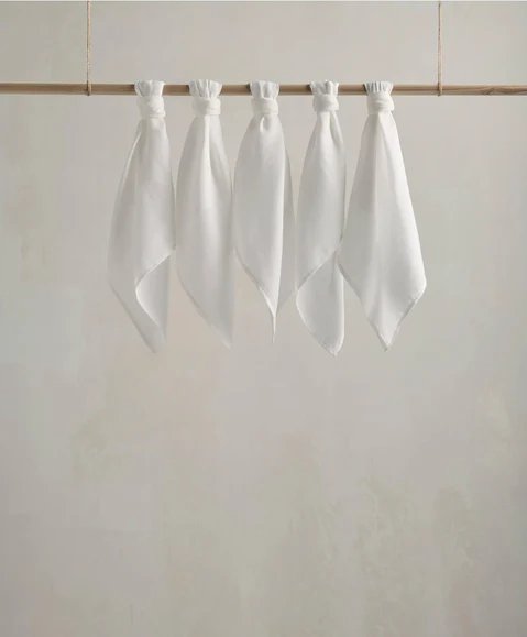 Muslin squares, white cloth squares hanging in a row with gathered tops