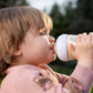Baby drinking from a bottle with clear level 3 teat