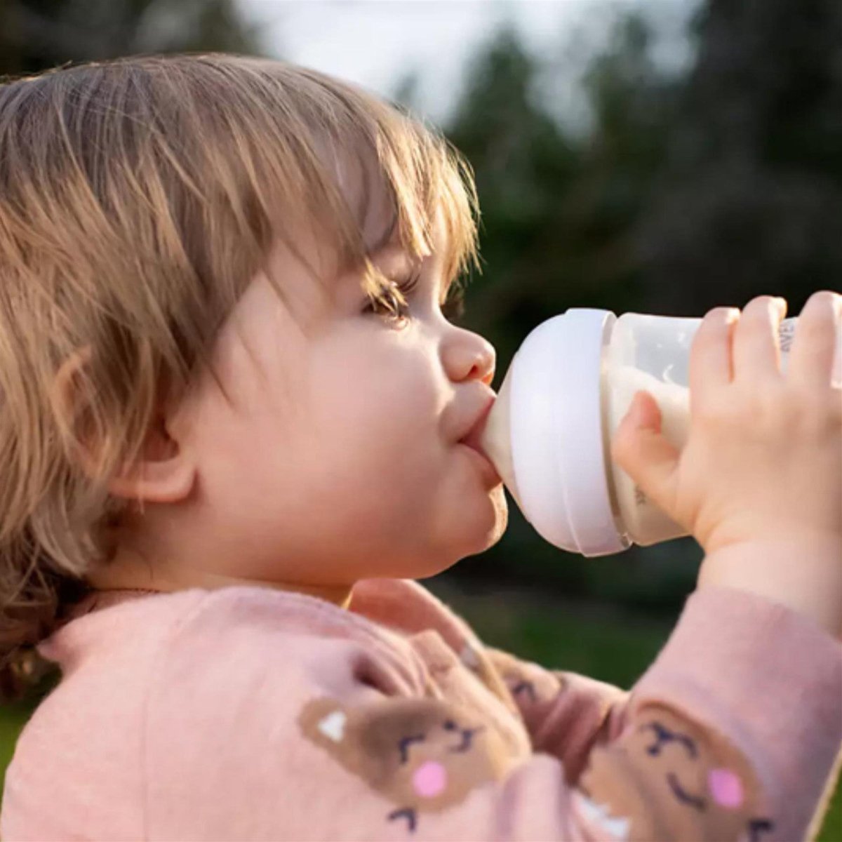 Baby drinking from a bottle with clear level 3 teat