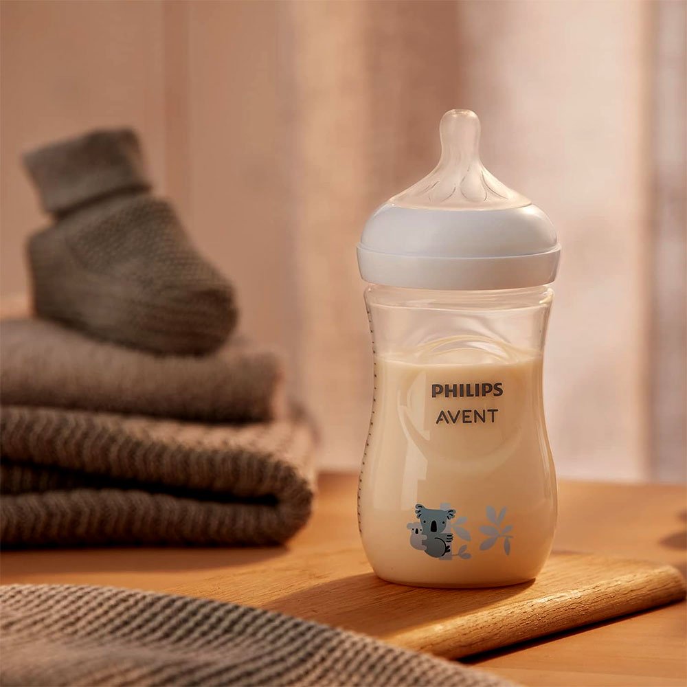 Natural Response baby bottle with handle, shown with milk inside and animal graphic