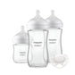 Set of four clear feeding bottles with white nipples and Philips Avent labels