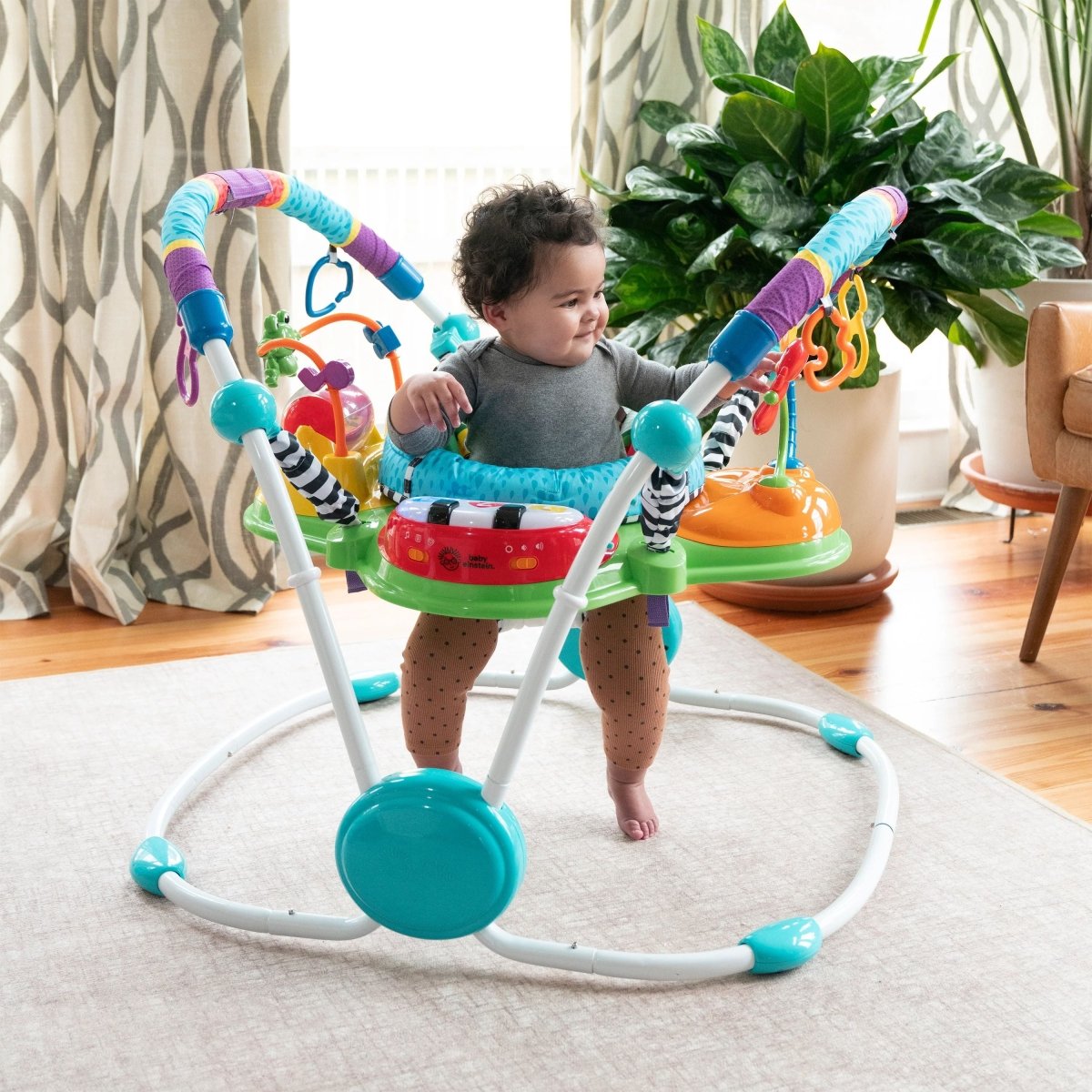 Toddler activity jumper with overhead toy bar and blue seat cushion