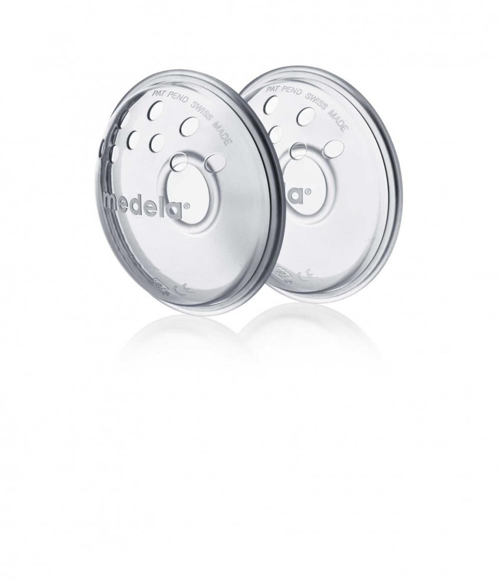 Pair of round medela nipple formers, clear-gray plastic with central valve holes
