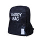 Nursery backpack with 'DADDY BAG' logo, front zip pocket, side mesh panel, ID tag