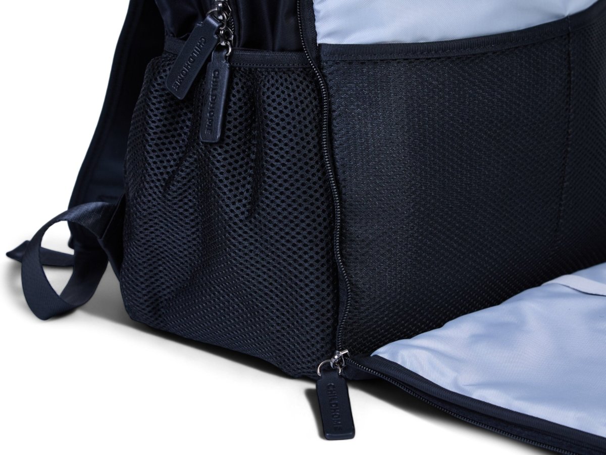 Nursery backpack with textured dark front panel, zip pocket, and adjustable shoulder strap