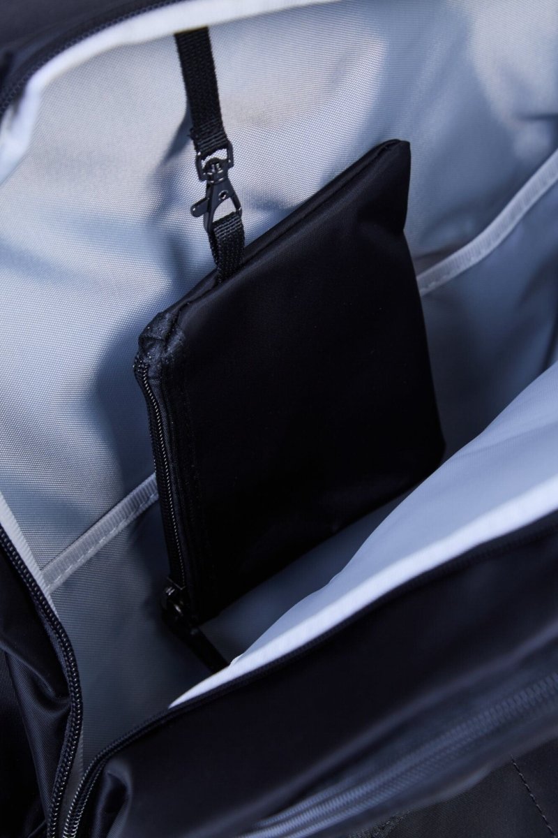 Nursery backpack interior with black pouch and partially open zipper compartment