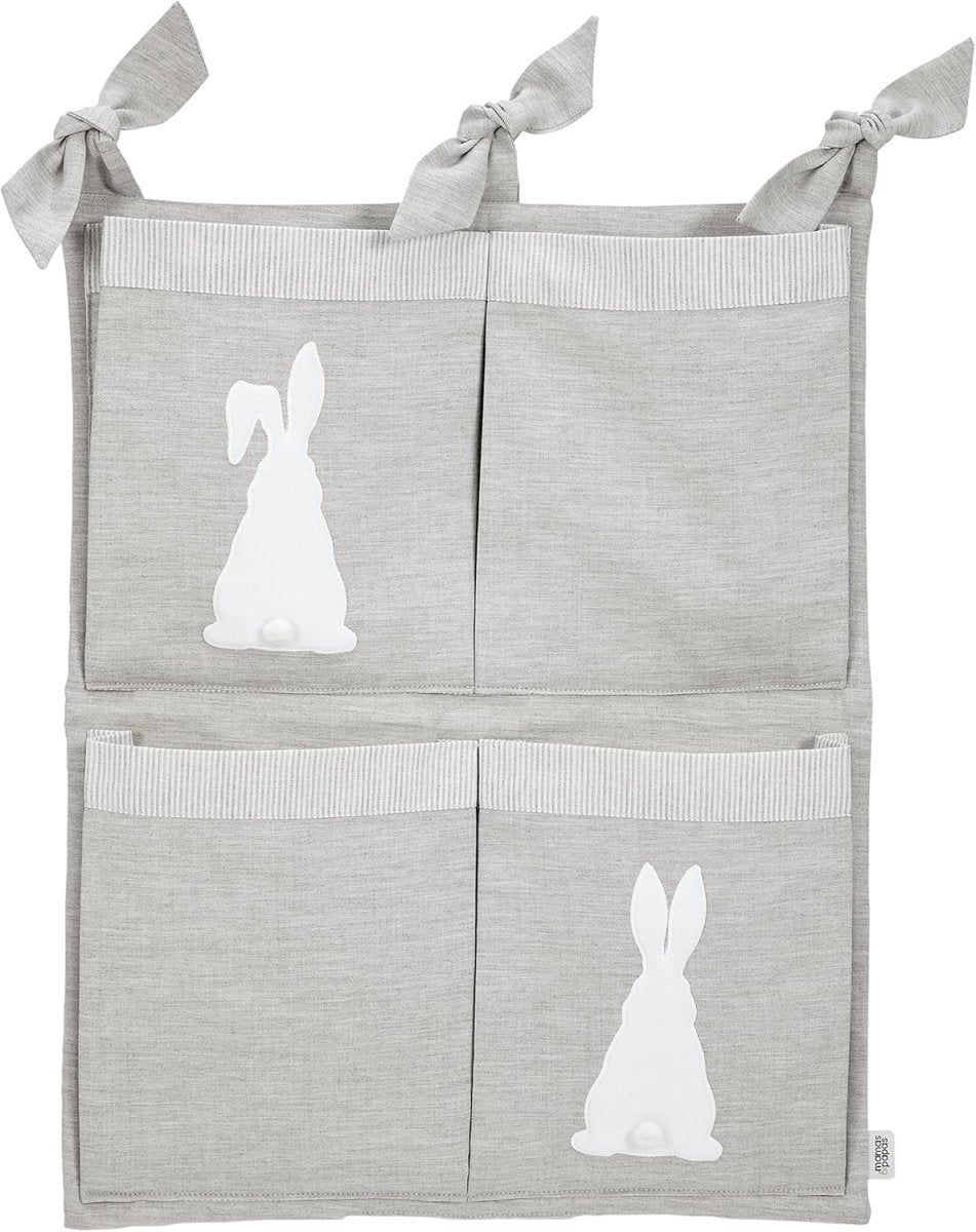 Grey hanging nursery organizer with four fabric pockets and white bunny appliques