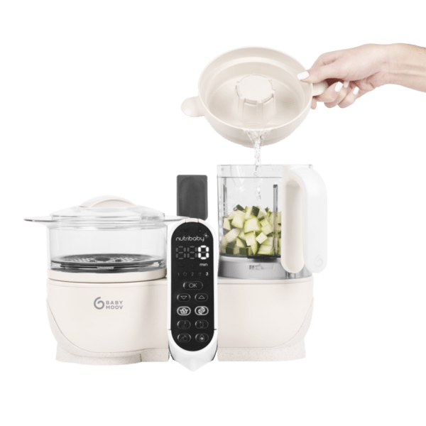 White baby food processor with one container open, diced vegetables inside, control panel.