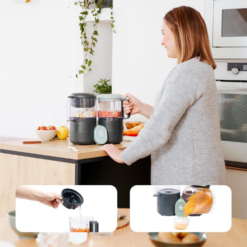 Baby food processor with two clear jars on countertop, dark gray base and mint lid