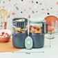 Baby food processor with two clear jars and mint lid; about 31 cm wide