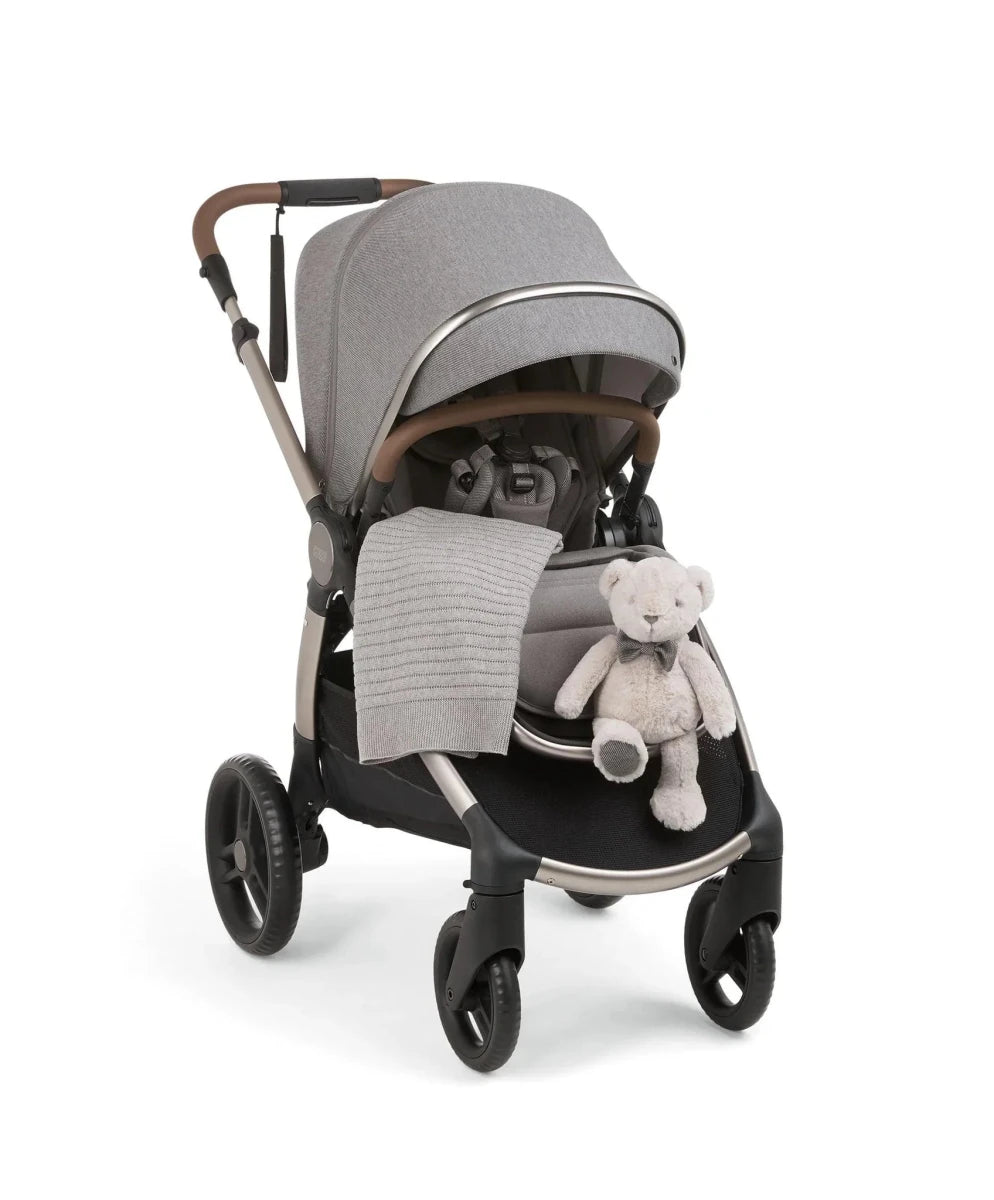 Heritage blanket on stroller seat, light gray textured knit with stitched pattern