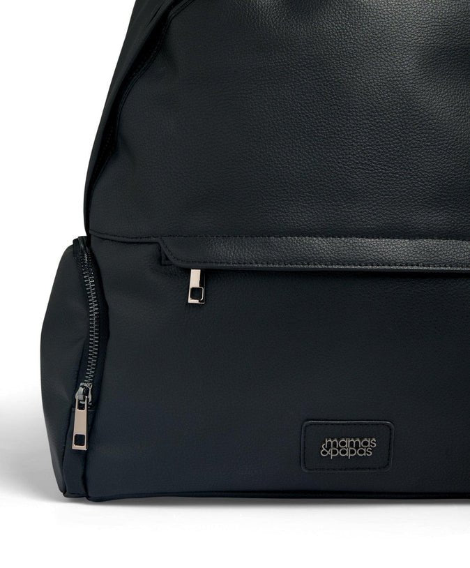 Black changing backpack with front zipper pocket and logo badge