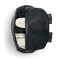 Black changing backpack with side compartment open, showing folded cloths