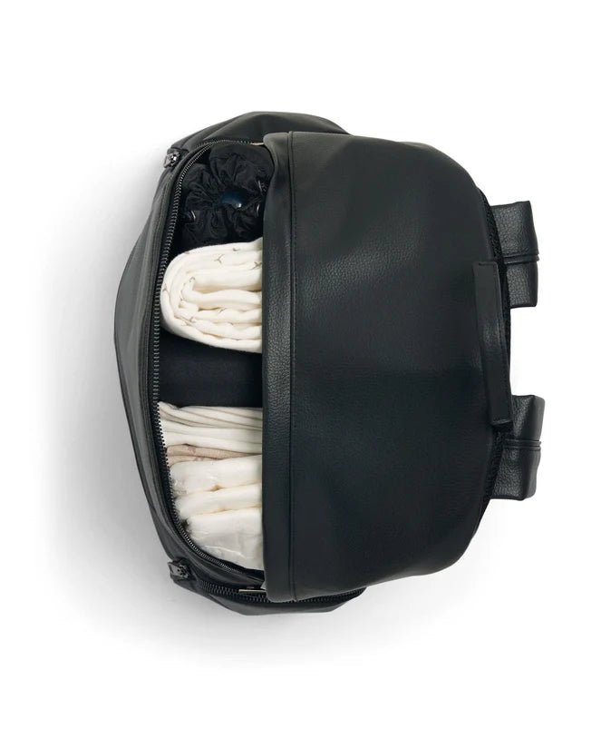 Black changing backpack with side compartment open, showing folded cloths