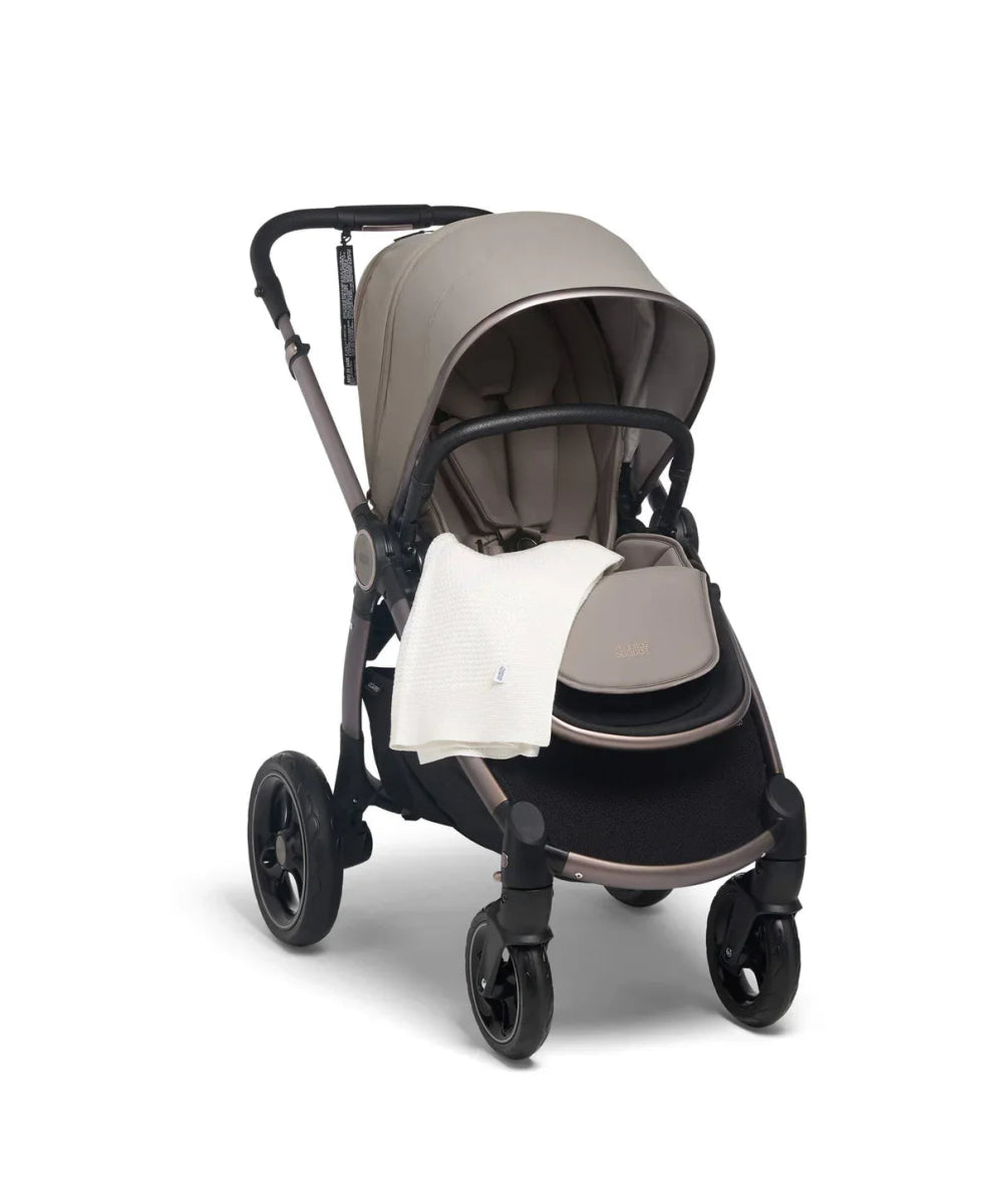 Travel blanket in off-white, draped on stroller seat
