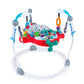 Baby activity jumper with circular base, red tray, blue supports, and dangling play pieces
