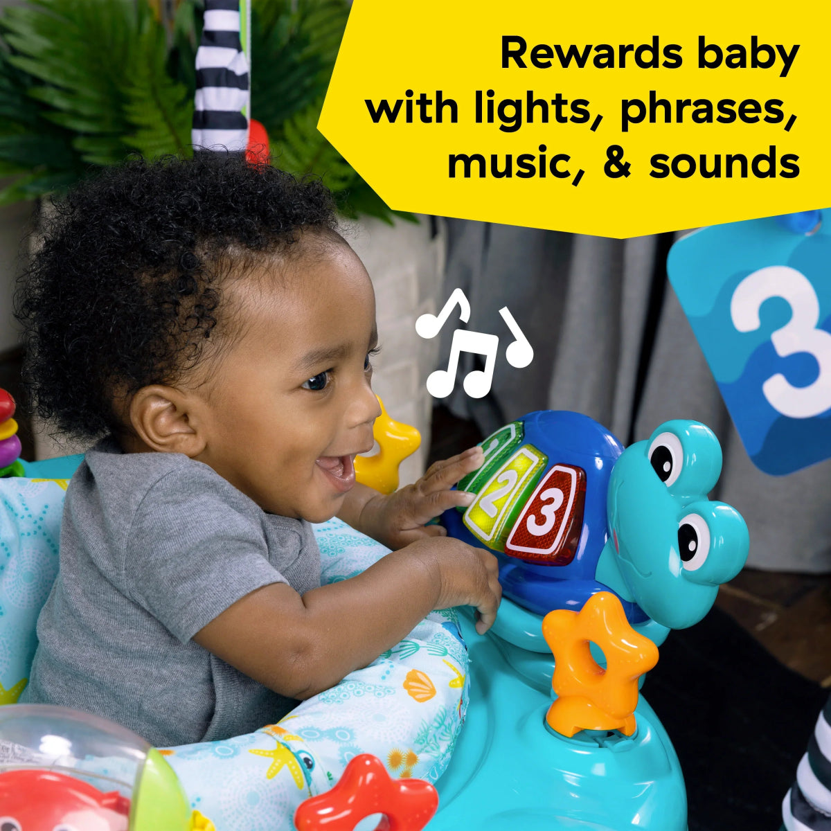 Baby interacting with a blue ocean activity jumper, pressing number and character toys