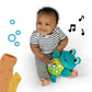 Teal frog plush with wide eyes, smiling face, and circular music button panel