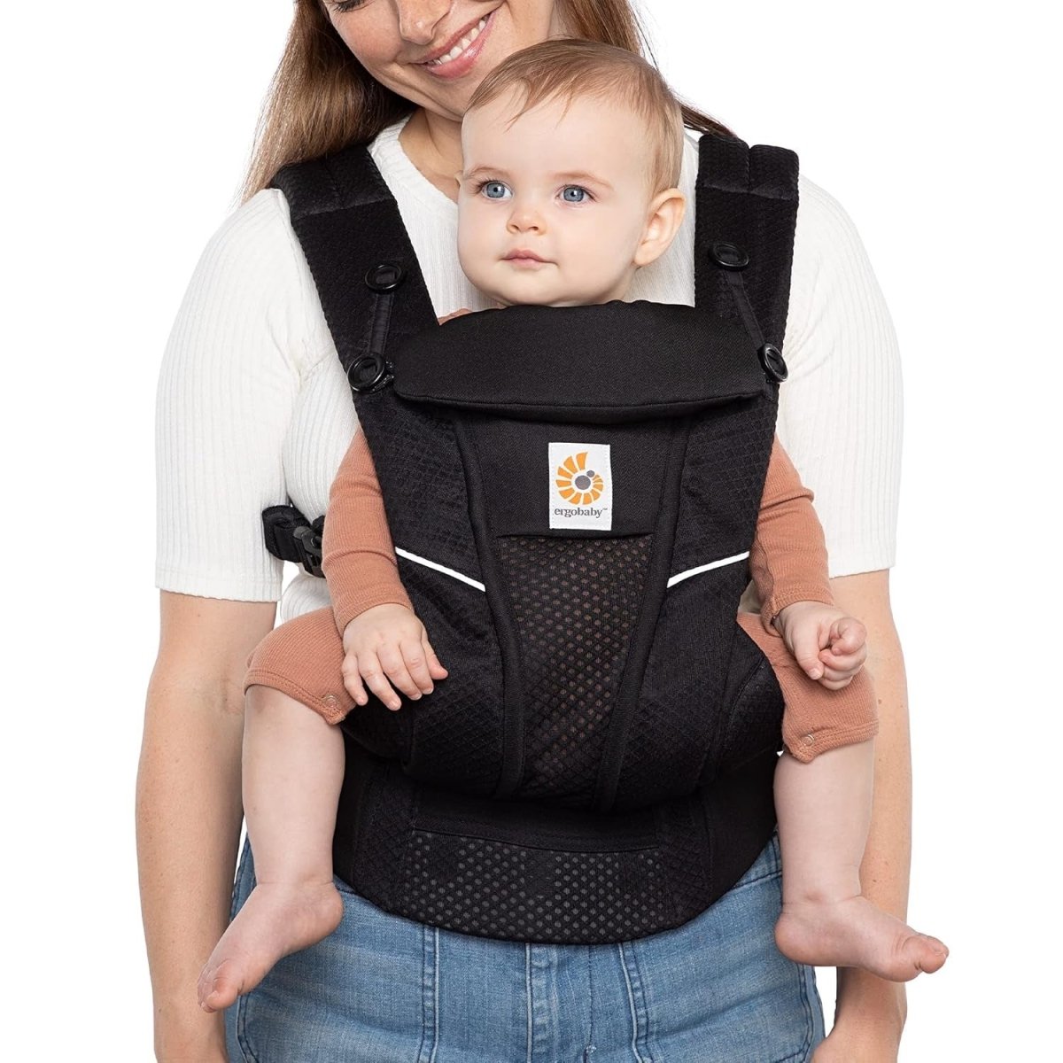 Black baby carrier worn by parent with infant in front pouch
