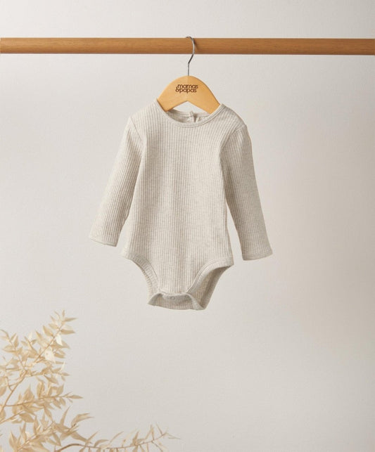 Oatmeal ribbed long-sleeve baby bodysuit hanging on wooden hanger