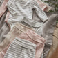 Folded ribbed long-sleeve bodysuits with horizontal stripes in oatmeal tones