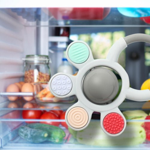 Baby orthopedic teether with rattle, mint and red textured pads with gray center teething disc.