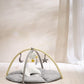 Round beige playmat with arched frame, hanging star and moon toys over cushioned pad