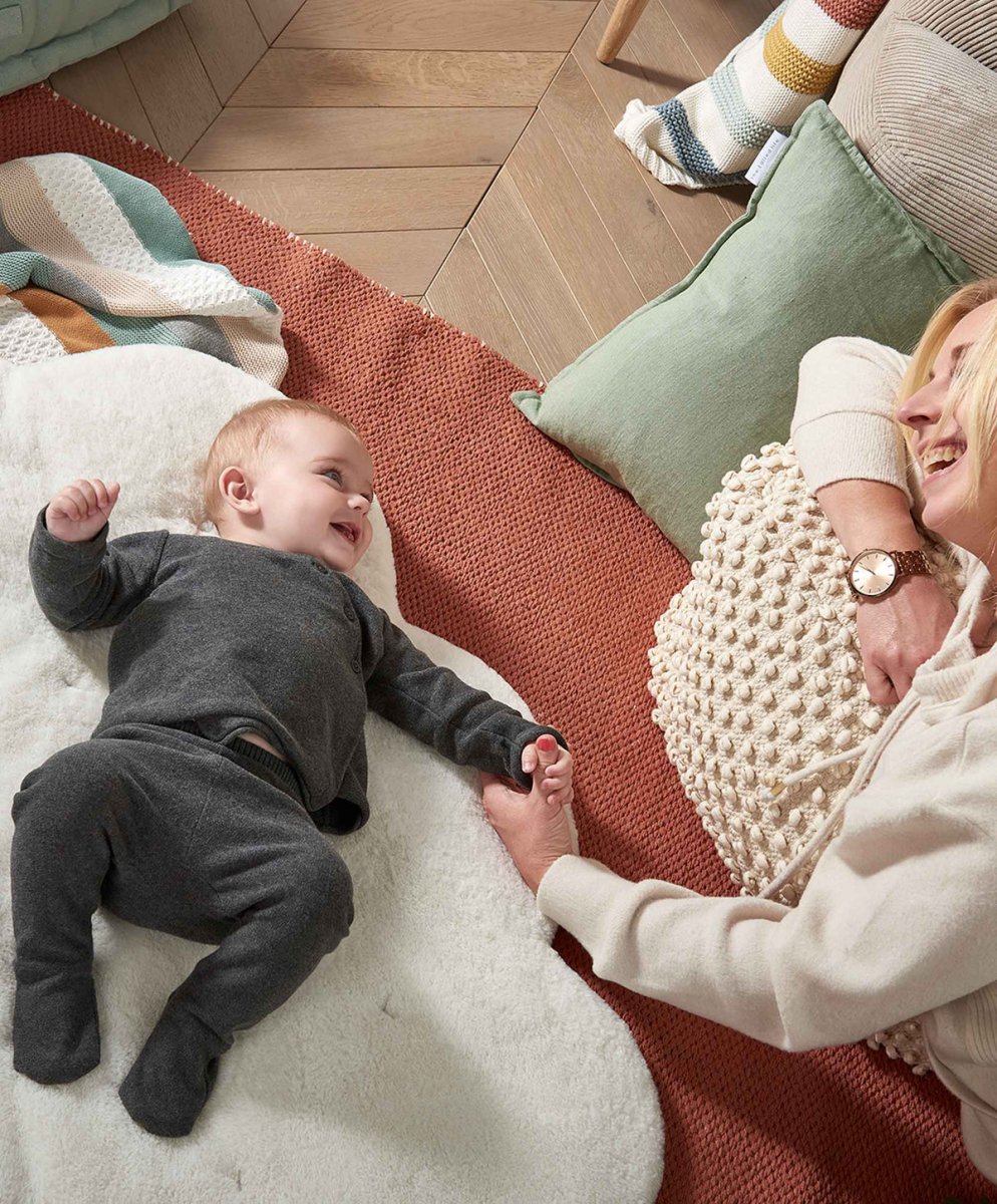 Soft white play mat with plush toy attachments