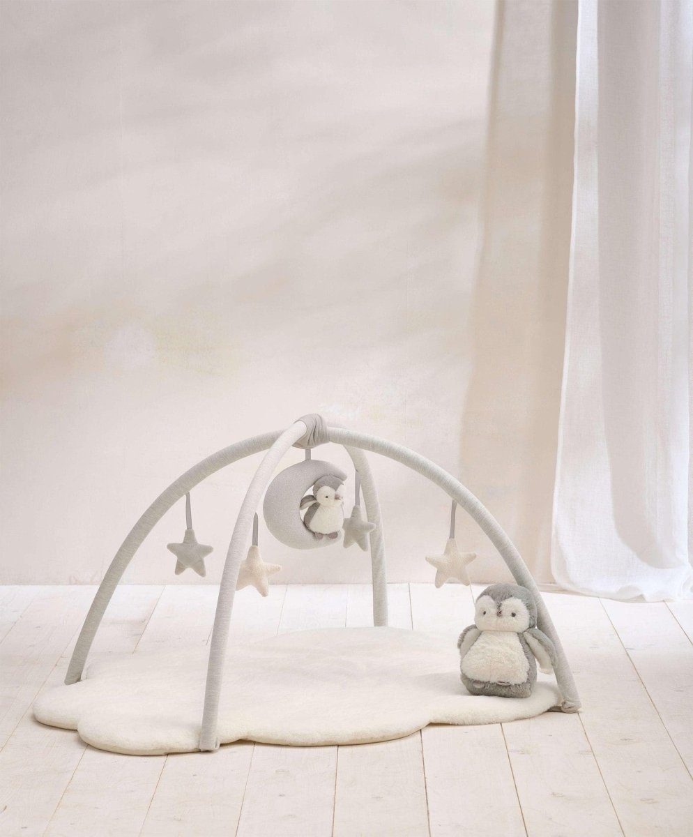 Cloud-themed play mat gym with arched frame and hanging star, moon, and plush toys