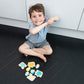 Wooden animal puzzle game pieces with animal faces scattered on floor