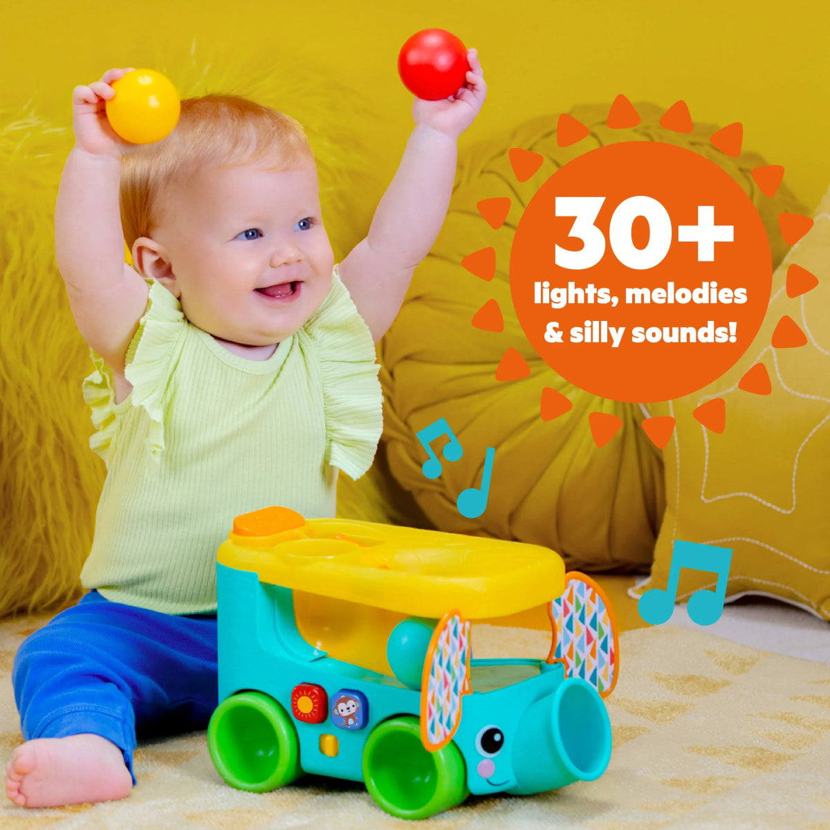 Ball pop bus toy on floor, blue elephant-head front with rolling green wheels